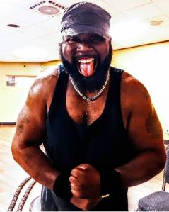 Shawn Cosby flexing after a workout.